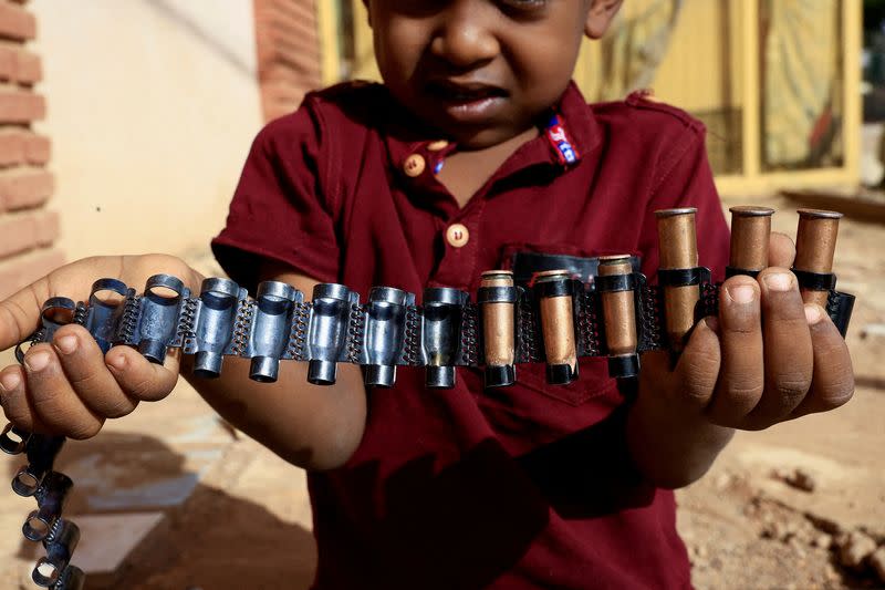 FILE PHOTO: Boy holds bullet cartridges in Khartoum North