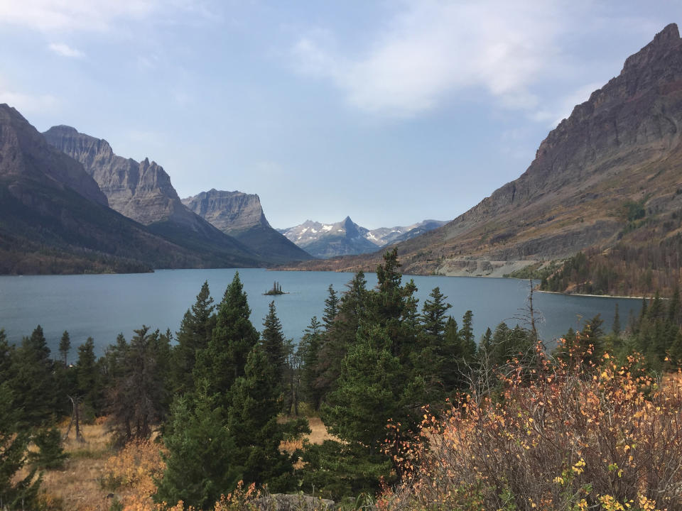 FILE - This Sept. 4, 2017 file photo shows a view from the Going-to-the-Sun Road in Glacier National Park in Montana, with a lake ringed by mountains and tall trees. Glacier National Park officials are teed off over a report that tourists were hitting golf balls off Going-to-the-Sun Road during a traffic delay. On Friday, July 19, 2019, Glacier spokeswoman Lauren Alley told the Missoulian the incident is under investigation. (AP Photo/Beth J. Harpaz, File)