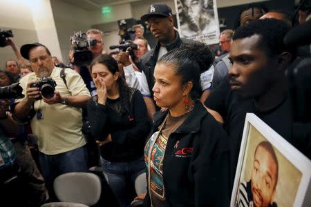 People listen to an explanation of the police commission's ruling in the shooting of unarmed black man by two patrolmen, after a Los Angeles Police Commission meeting, June 9, 2015. REUTERS/Patrick T. Fallon