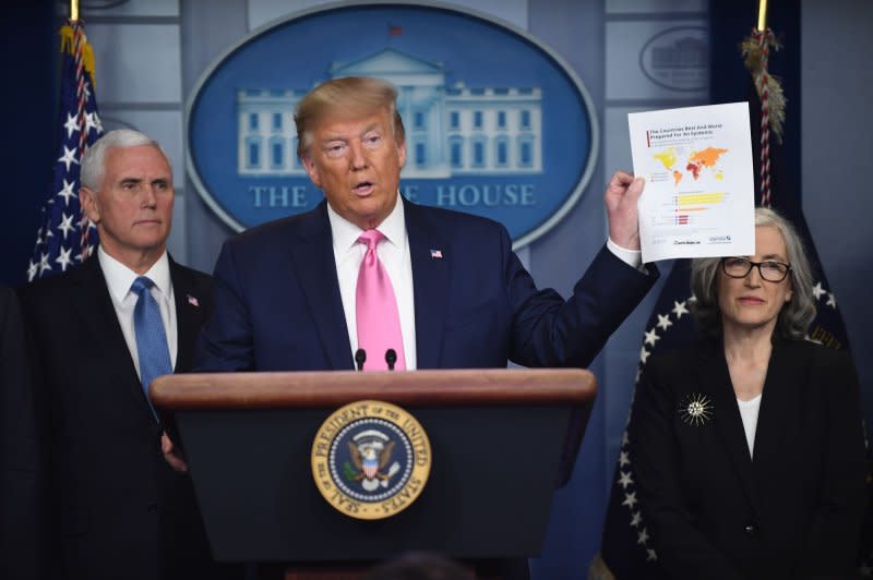 President Donald Trump holds up a map showing the United States as No. 1 in preparedness for the coronavirus pandemic at a press briefing at the White House on February 26, 2020. Trump said the United States had 15 COVID-19 cases, and the number "within a couple of days is going to down to close to zero." Two days later, he called the coronavirus a "hoax." File Photo by Pat Benic/UPI