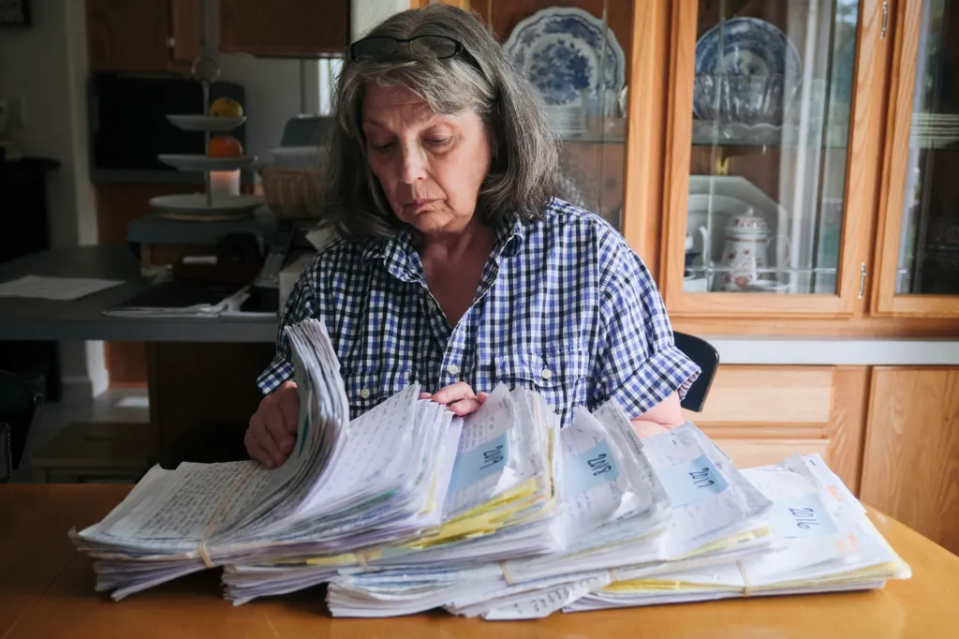 Susan Ottele looks through hundreds of handwritten letters that her son, Adam Collier, mailed to her from prison between 2016 and 2020.