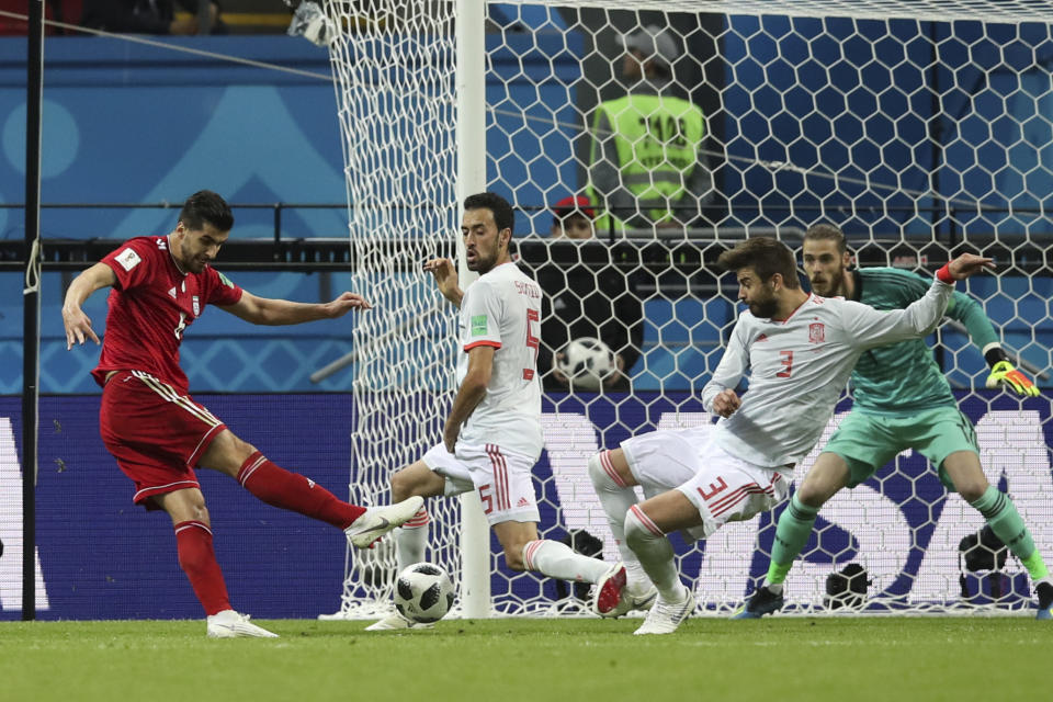 <p>Saeid Ezatolahi kicks the ball past the Spain defence and goalkeeper… </p>