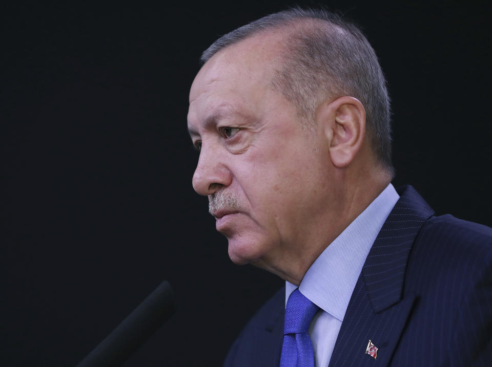 Turkish President Recep Tayyip Erdogan speaks to reporters before a visit to the United States, in Ankara, Turkey, Tuesday, Nov. 12, 2019. Erdogan warned European nations Tuesday that his country could release all the Islamic State group prisoners it holds and send them to Europe, in response to EU sanctions over Cyprus.(Presidential Press Service via AP, Pool)