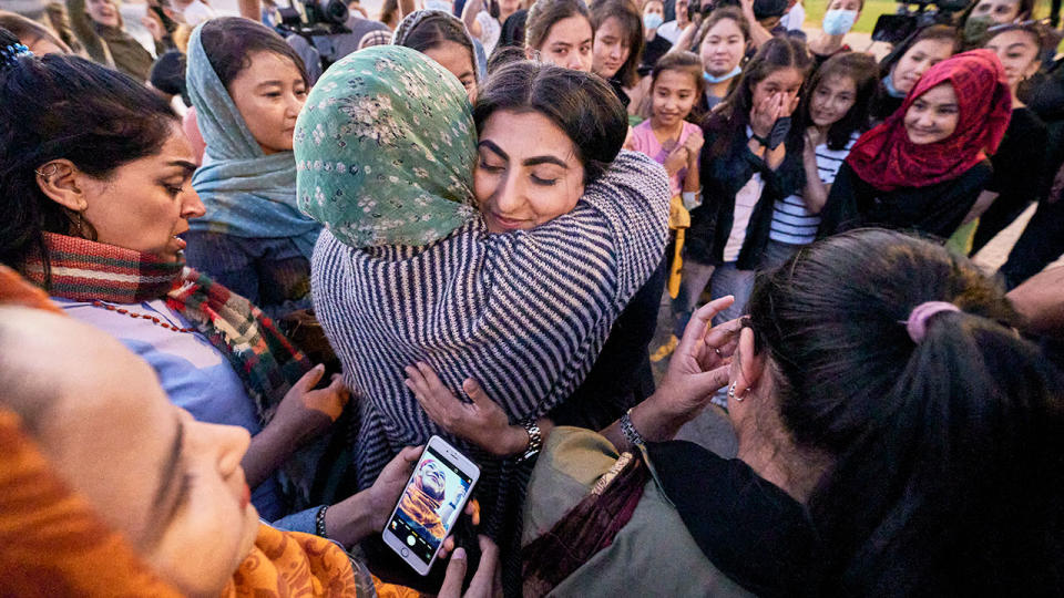 Pictured here, members of the Afghan women's national football team celebrate after fleeing to Portugal.