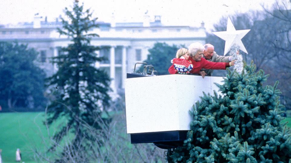 <strong>1992</strong>: Barbara Bush in a cherrypicker, placing a star on a tree in the White House grounds. - Jeff Markowitz/Pool/Consolidated News Pictures/Getty Images