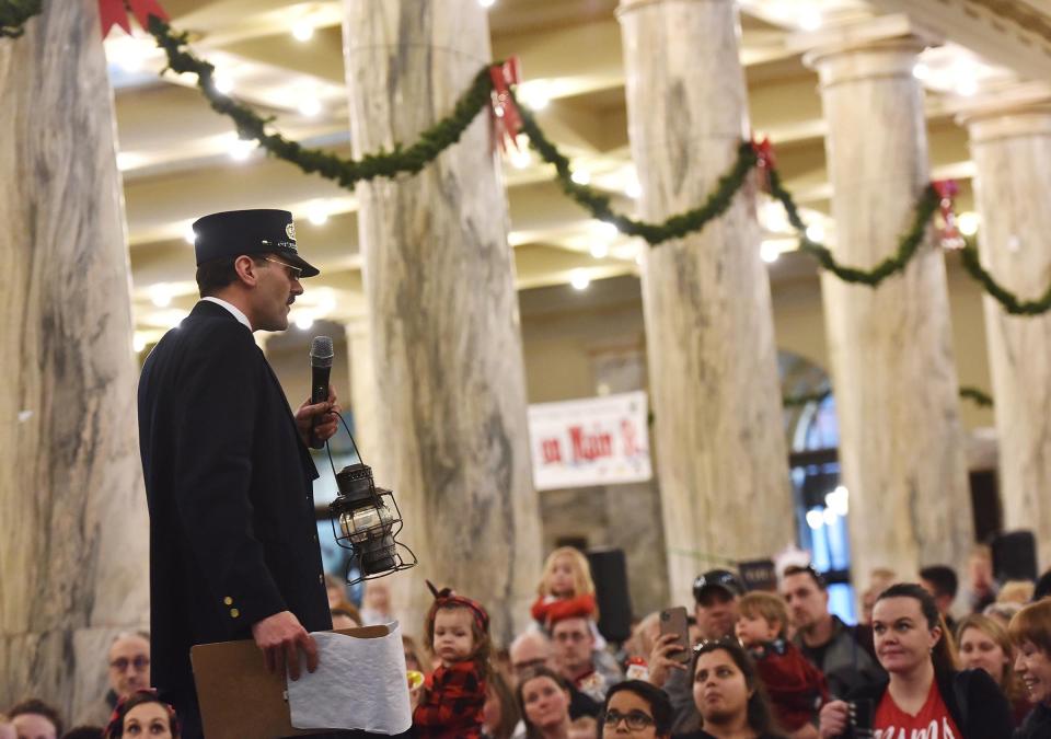 In this December 2019 file photo, the conductor from the Polar Express train with the Adirondack Scenic Railroad speaks to passengers at Utica's Union Station. The event has been postponed for 2020 due to the coronavirus pandemic.