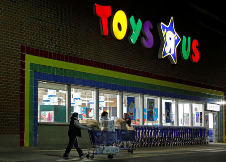 FILE PHOTO: Consumers leave a Toys R Us store with full shopping carts after shopping on the day dubbed "Black Friday" in Framingham, Massachusetts, U.S., November 25, 2011. REUTERS/Adam Hunger/File Photo