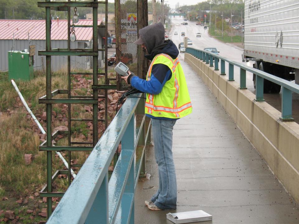 A staff member from East Dakota Water Development District measures the Big Sioux River for temperature, dissolved oxygen and conductivity at the Cliff Avenue bridge just downstream from Smithfield Foods in Sioux Falls in 2012.