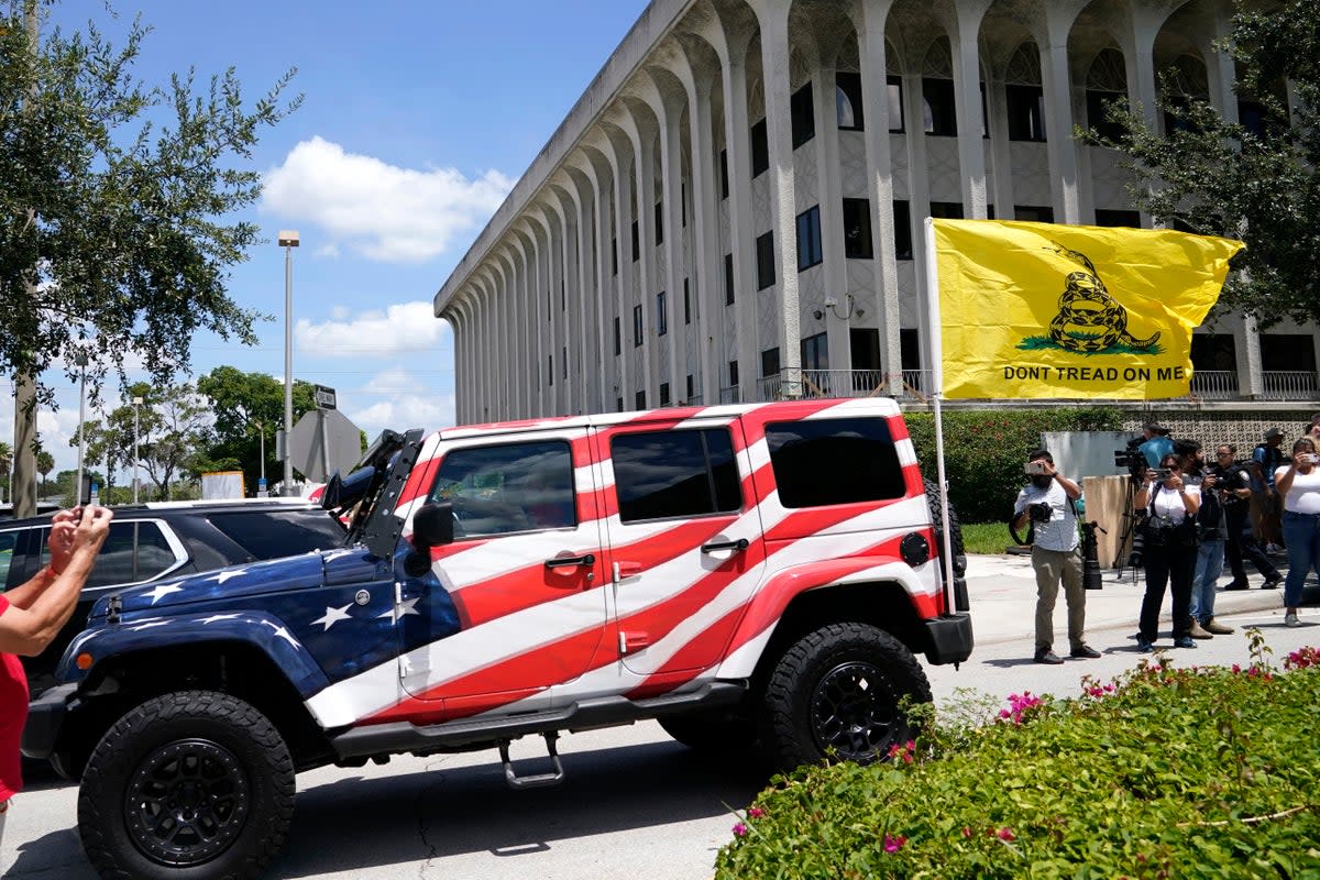 A vehicle painted with the American flag drives past the Paul G. Rogers Federal Courthouse, Thursday, Aug. 18, 2022, in West Palm Beach, Fla (AP)