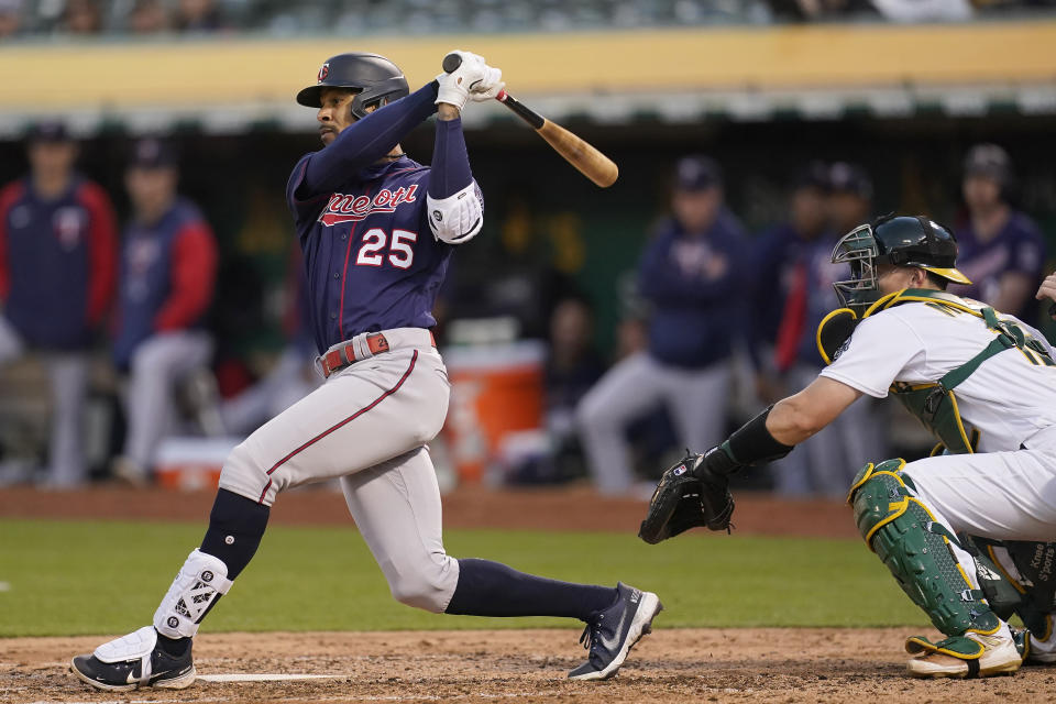 Minnesota Twins' Byron Buxton (25) hits an RBI-single in front of Oakland Athletics catcher Sean Murphy during the fifth inning of a baseball game in Oakland, Calif., Monday, May 16, 2022. (AP Photo/Jeff Chiu)