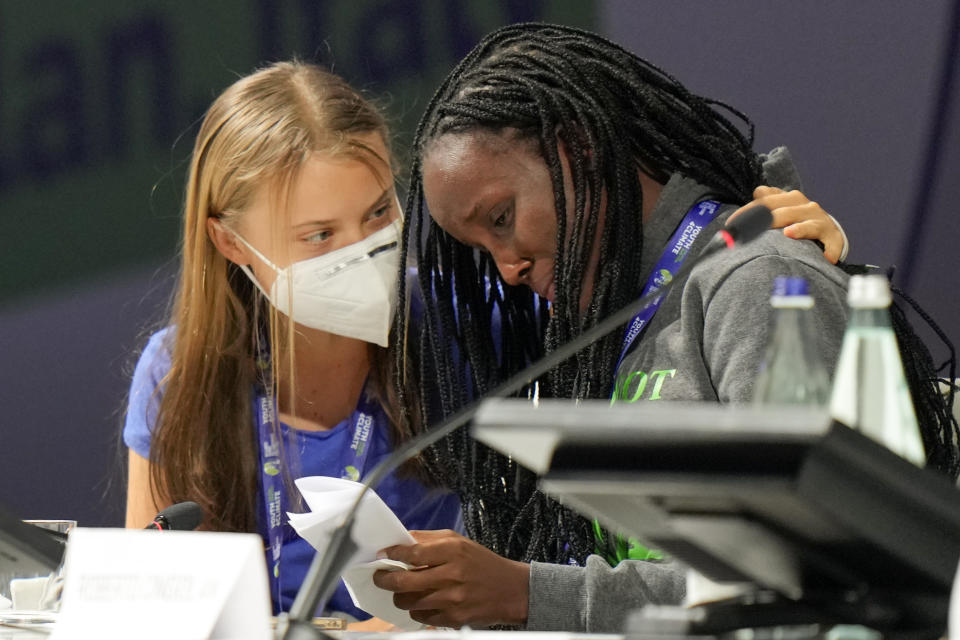 Ugandan climate activist Vanessa Nakate, right, is comforted by Swedish activist Greta Thunberg as she is overcome by emotion after speaking at the start of a three-day Youth for Climate summit in Milan, Italy, Tuesday, Sept. 28, 2021.(AP Photo/Luca Bruno)