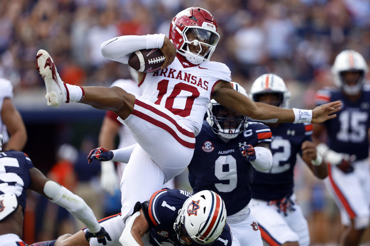 Arkansas quarterback Taylen Green (10) tires to hurdle Auburn safety Jerrin Thompson (1) as he carries the ball during the first half of an NCAA college football game, Saturday, Sept. 21, 2024, in Auburn, Ala.(AP Photo/Butch Dill)