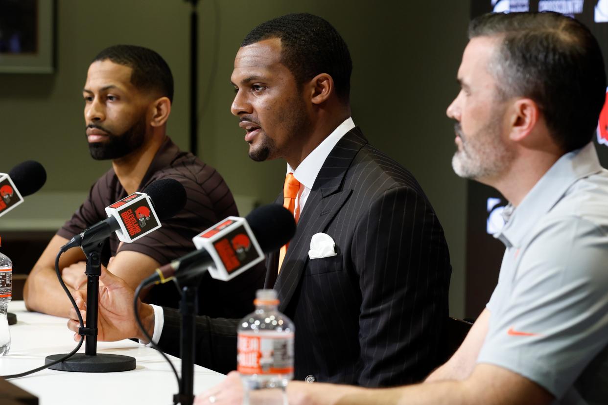Cleveland Browns new quarterback Deshaun Watson, center, speaks during a news conference at the NFL football team's training facility as general manager Andrew Berry, left, and head coach Kevin Stefanski listen, Friday, March 25, 2022, in Berea, Ohio. (AP Photo/Ron Schwane)