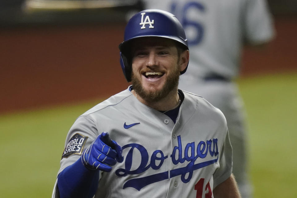 Los Angeles Dodgers' Max Muncy celebrates a home run against the Tampa Bay Rays during the fifth inning in Game 5 of the baseball World Series Sunday, Oct. 25, 2020, in Arlington, Texas. (AP Photo/Eric Gay)