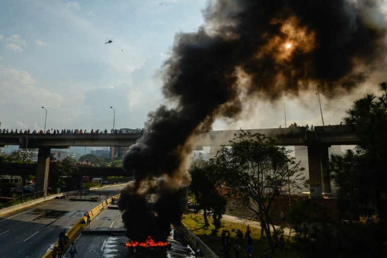 Venezuelan opposition activists set up barricades during a demonstration against President Nicolas Maduro in Caracas, on April 24, 2017