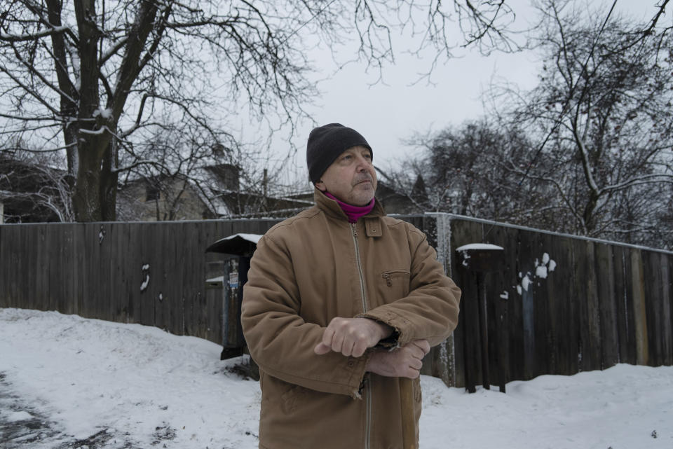 Valeriy Sholomitsky, 61, poses for a photo after clearing the snow at a street named after Fyodor Dostoevsky, soon to be renamed to honor Andy Warhol, the late Pop Art visionary from the United States whose parents had family roots in Slovakia, across Ukraine's western border, in Kyiv, Ukraine, Thursday, Dec. 15, 2022. Ukraine is accelerating efforts to erase the vestiges of Soviet and Russian influence from its public spaces by pulling down monuments and renaming hundreds of streets to honor its own artists, poets, soldiers, independence leaders and others — including heroes of this year’s war. (AP Photo/Vasilisa Stepanenko)
