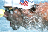 Michael Phelps competes in the 100-meter butterfly during the Arena Grand Prix, Thursday, April 24, 2014, in Mesa, Ariz. It is Phelps' first competitive event after a nearly two-year retirement. (AP Photo/Matt York)