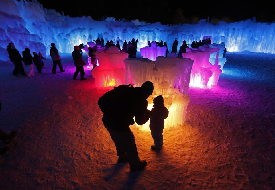 Bruce McCafferty and his son, Dougie, pause while exploring the ice formations growing at Ice Castles in North Woodstock, N.H. (Photo: Robert F. Bukaty/AP)