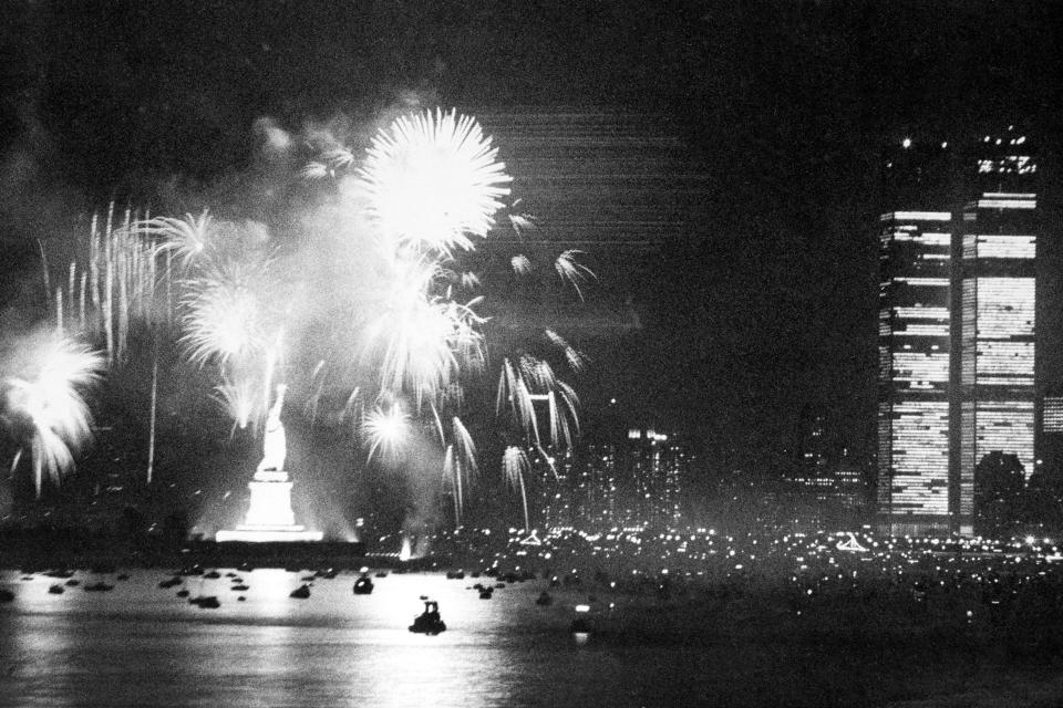 FILE - Fireworks at the Statue of Liberty light the sky as New York City celebrates the Declaration of Independence bicentennial anniversary, on July 4, 1976. The display ended a day of festivities in the New York Harbor, with boats and tall ships from across the world gathered for Operation Sail. Also seen is Lower Manhattan with the Twin Towers of the World Trade Center at right. (AP Photo, File)