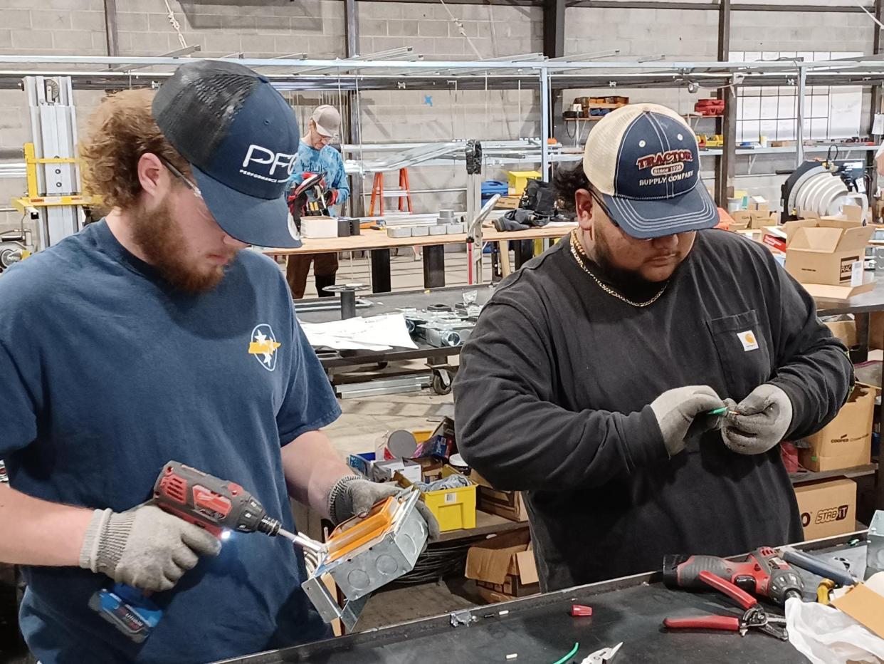 Braylon Gann and Jessie Mota work at Enterprise Solutions in December 2021. Gann and Mota were students at John Overton High School and participated in a work-based learning program. They have since graduated.