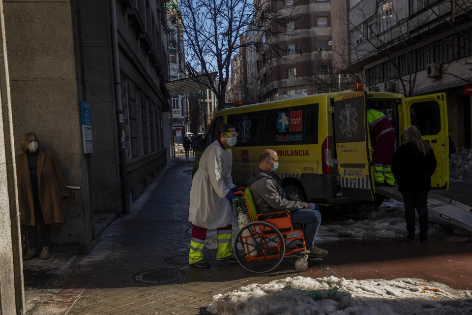 A patient infected with COVID-19 is transferred to the new Nurse Isabel Zendal Hospital in Madrid Madrid, Spain, Monday, Jan. 18, 2021. As the coronavirus curve of contagion turned increasingly vertical after Christmas and New Year's, the Zendal has been busy. On Monday, 392 virus patients were being treated, more than in any other hospital in the Madrid region. (AP Photo/Bernat Armangue)