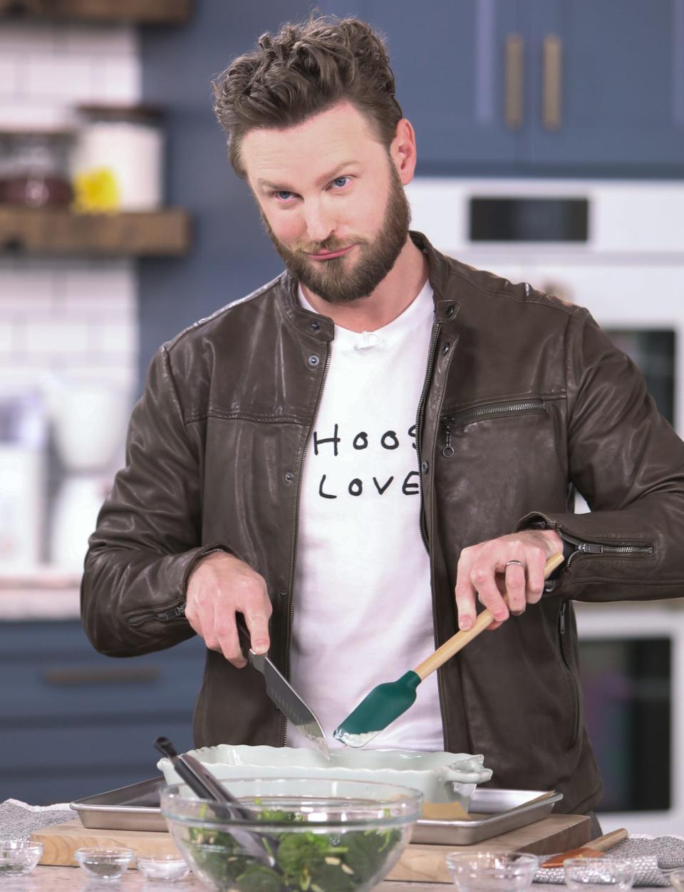 <p><em>Queer Eye</em>'s Bobby Berk gets to work in the kitchen on Wednesday while shooting a segment on Hallmark Channel's <em>Home & Family</em> in Universal City, California.</p>