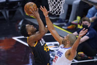 Los Angeles Clippers forward Nicolas Batum (33) defends as Utah Jazz guard Donovan Mitchell, left, goes to the basket during the first half of Game 2 of a second-round NBA basketball playoff series Thursday, June 10, 2021, in Salt Lake City. (AP Photo/Rick Bowmer)