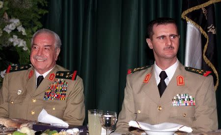 Syrian President Bashar al-Assad (R) and Defence Minister Mustafa Tlass during a banquet held on the occasion of Syrian Army Day late on August 1, 2000. Handout via REUTERS/File photo