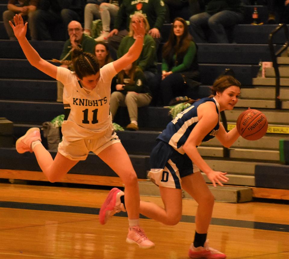 Dolgeville Blue Devil Payton Comstock dribbles past Hamilton's Logan Langel Monday during their Section III semifinal at East Syracuse-Minoa High School.