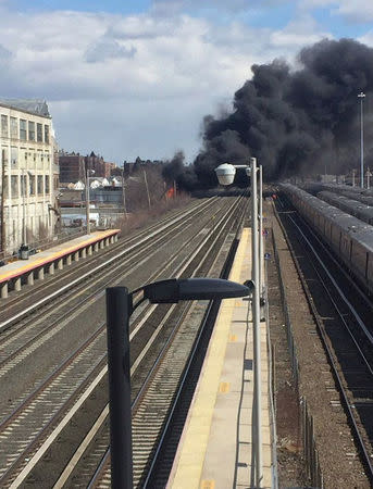 A fire breaks at a New York recycling plant next to the tracks of the Long Island Rail Road in New York City, New York, US., March 16, 2018 in this picture obtained from social media. MTA LONG ISLAND RAIL ROAD/via REUTERS