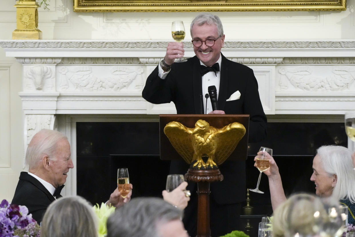 President Joe Biden raises a glass as the National Governors Association Chair New Jersey Gov. Phil Murphy toasts during a dinner reception for governors and their spouses in the State Dining Room of the White House, Saturday, Feb. 11, 2023, in Washington. (AP Photo/Manuel Balce Ceneta)