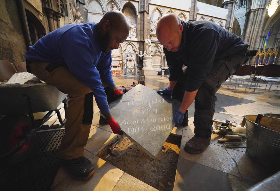 Members of staff Mark Croll, right, and Paul Atkinson install the memorial stone (Jonathan Brady/PA)