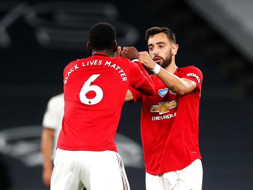 Bruno Fernandes, right, celebrates with Paul Pogba: PA