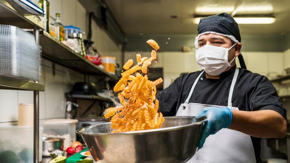 Chef tossing chips