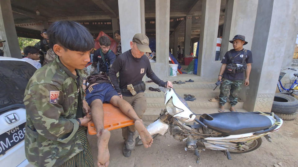 In this undated photo released by the Free Burma Rangers, Dave Eubank, center, founder of the Free Burma Rangers, evacuates the wounded after a Buddhist monastery sheltering civilians displaced by fighting in the town of Papun, Karen state, Myanmar was attacked on March 31, 2024 by a regime warplane. (Free Burma Rangers via AP)