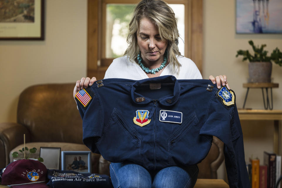 Doreen Jenness, the widow of Air Force Capt. Jason Jenness, pulls out a portion of his uniform during an interview with the Associated Press in Missoula, Mont., Aug. 26, 2023. Capt. Jenness was a Malmstrom missileer who died of non-Hodgkin lymphoma in 2001 at the age of 31. (AP Photo/Tommy Martino)
