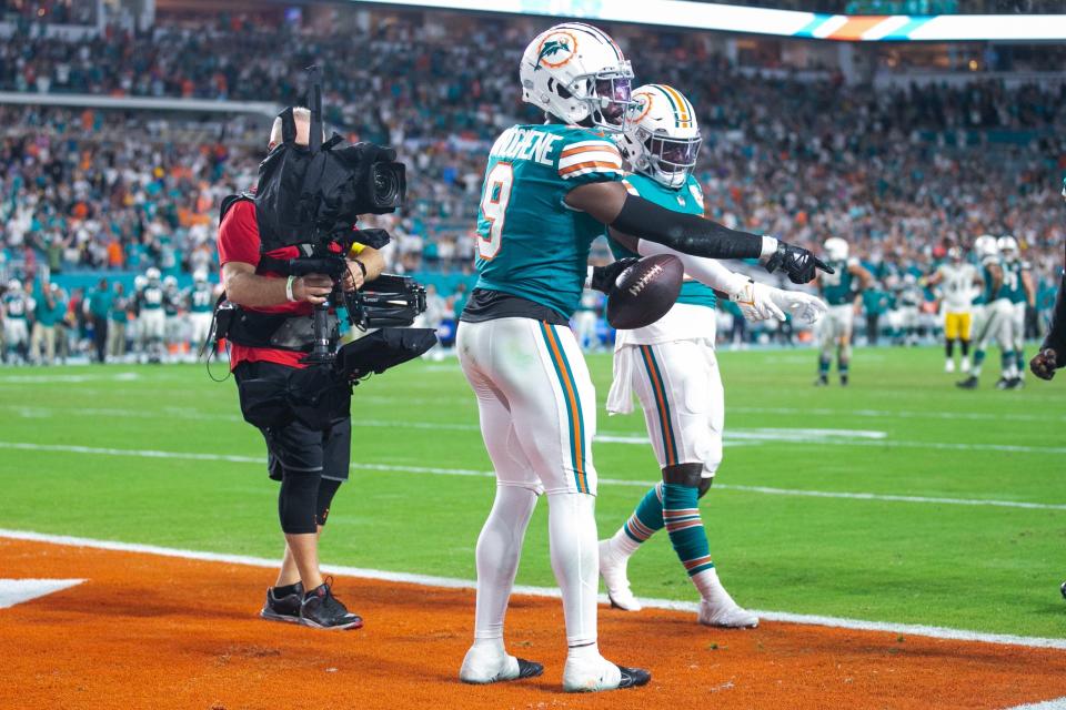 Dolphins cornerback Noah Igbinoghene (9) points to the spot where he believed his feet came down in-bounds near the end zone pylon for an interception that sealed Miami's win over the Pittsburgh Steelers.