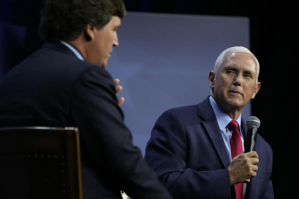 Republican presidential candidate former Vice President Mike Pence talks with moderator Tucker Carlson, left, during the Family Leadership Summit, Friday, July 14, 2023, in Des Moines, Iowa. (AP Photo/Charlie Neibergall)