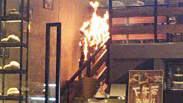 Tang had sat in a blind spot of the cafe and ran down the stairs, screaming and engulfed in flames. Photo: People's Daily China