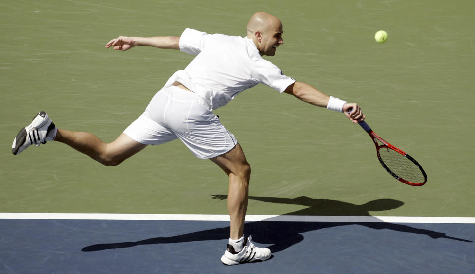 FILE - Andre Agassi makes a return against Benjamin Becker, of Germany, at the U.S. Open tennis tournament in New York, Sunday, Sept. 3, 2006. Agassi watches pickleball videos, goes to his club every other day for pickleball matches and even had a hand in designing a pickleball paddle. He’s become driven with unlocking the best pickleball version of himself — just like he strived to do on the tennis court over a career that included eight Grand Slam singles titles.(AP Photo/Julie Jacobson, File)