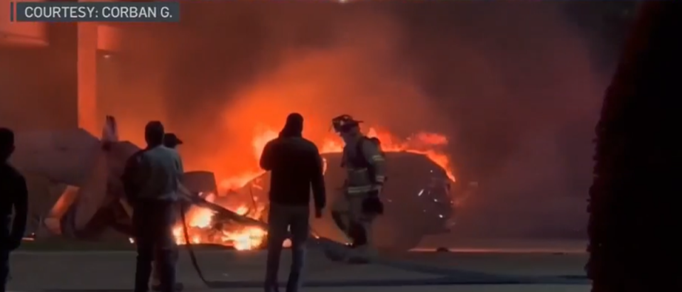 Firefighters can be seen extingushing the flames at the scene (CBS)
