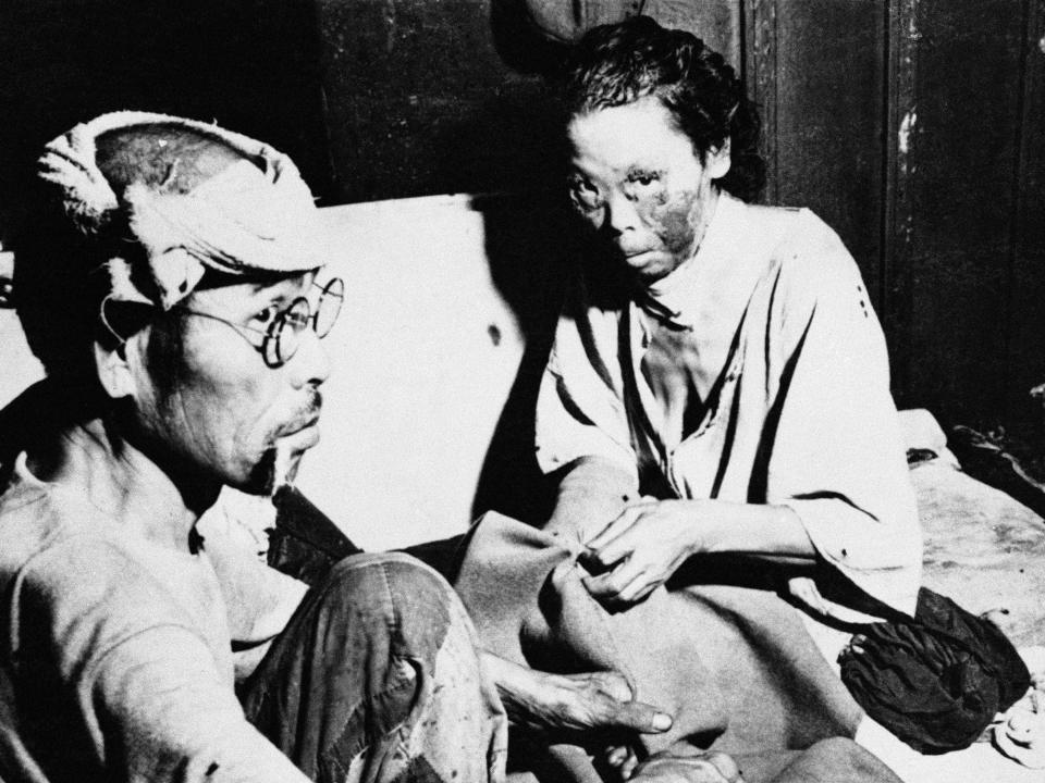Two victims of the atomic bombing sit in a converted hospital in October 1945.