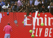 Spain's Rafael Nadal signs autographs after defeating Bolivia's Hugo Dellien in their first round singles match at the Australian Open tennis championship in Melbourne, Australia, Tuesday, Jan. 21, 2020. (AP Photo/Lee Jin-man)
