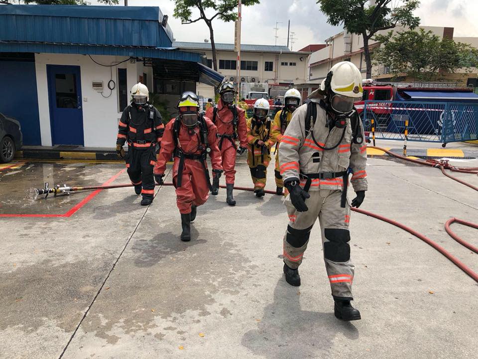 HazMat specialists in protective suits entering the affected building on January 26, 2018. (PHOTO: Singapore Civil Defence Force/Facebook)