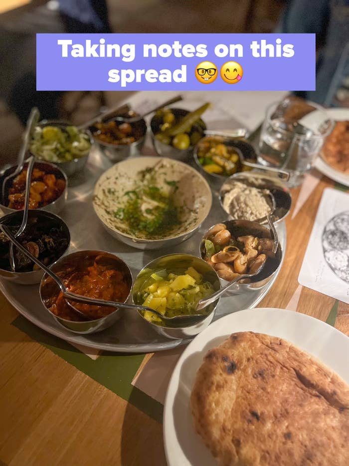 A bunch of dips and pita at a restaurant.