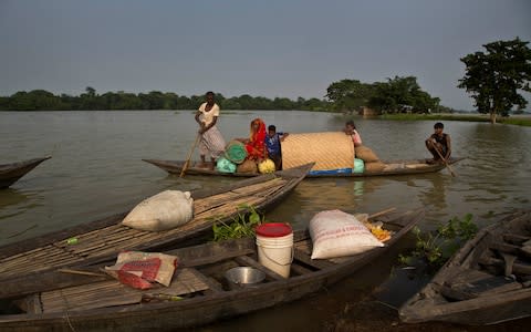 Some 4.5 million have been affected by the flooding in Assam - Credit: AP Photo/Anupam Nath
