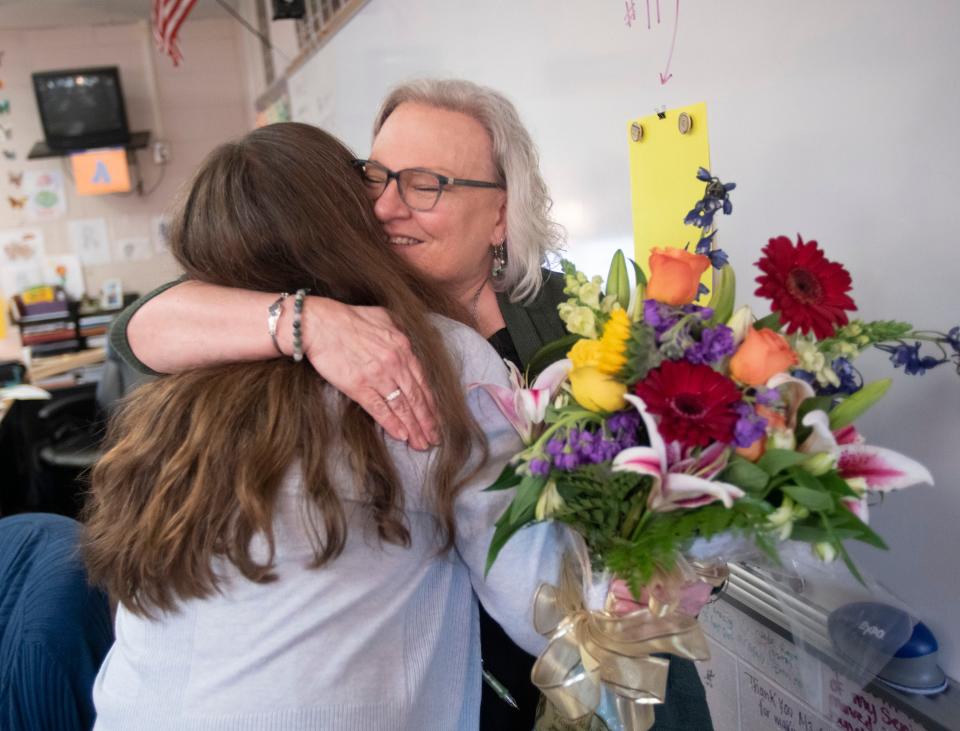 Navarre High School teacher Karen Cody receives a congratulatory hug from a colleague after being named the district Teacher of the Year on Wednesday, Jan. 25, 2023.