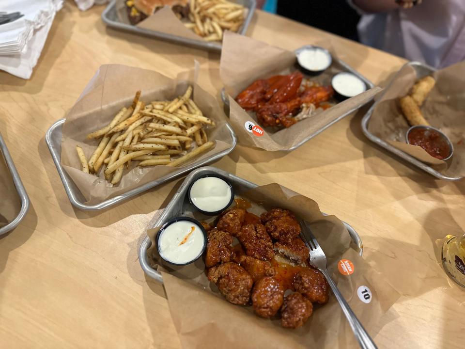 chicken wings, fries, on trays on table at buffalo wild wings