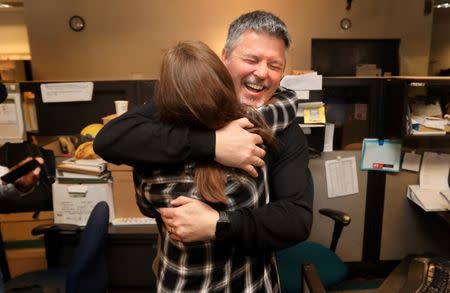 Santa Rosa Press Democrat Managing Editor Ted Appel and Features Editor Corinne Asturias celebrate winning the Pulitzer Prize for Breaking News Reporting awarded to the staff of the Press Democrat for the coverage of the October fires in Sonoma County in the newsroom in Santa Rosa, California, U.S., April 16, 2018 . Courtesy Kent Porter/The Press Democrat/Handout via REUTERS