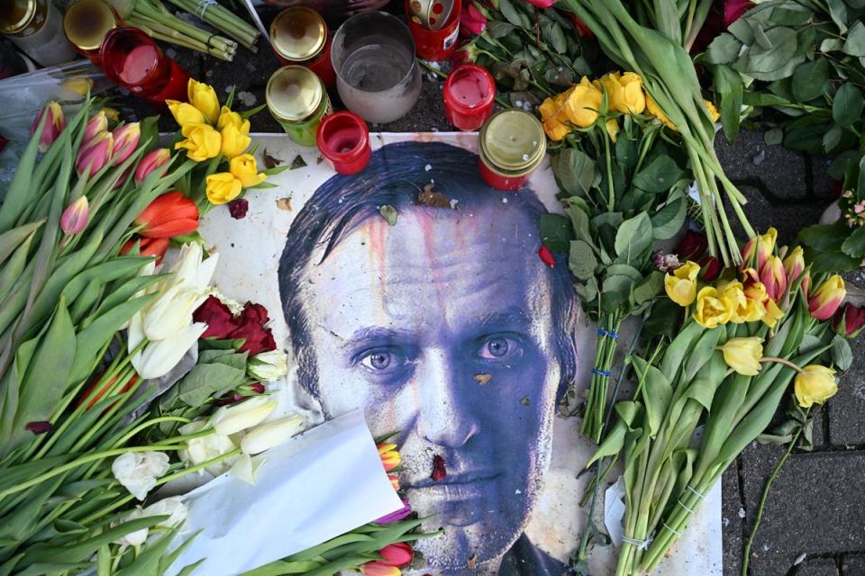 Flowers are seen placed around a portrait of late Russian opposition leader Alexei Navalny at a makeshift memorial (AFP via Getty Images)